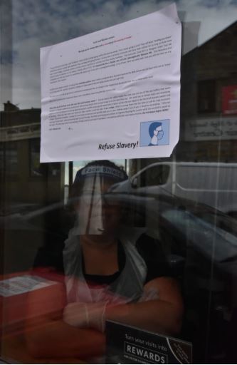'DAMAGING': Anti-mask conspiracy leaflets glued to shop doors