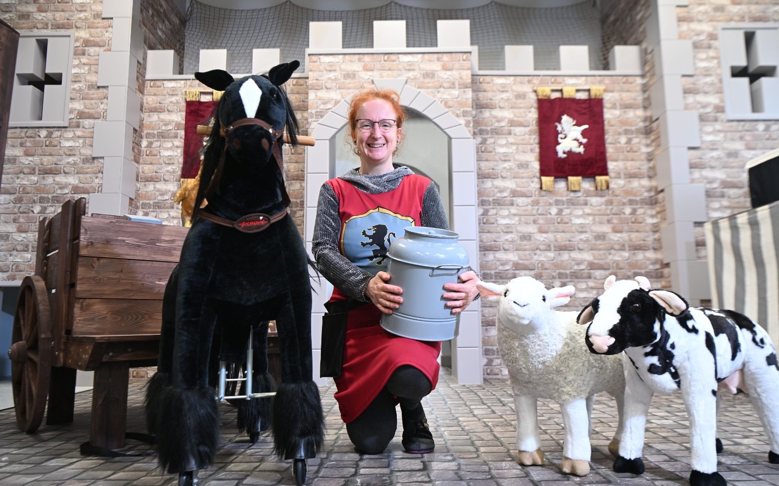 Inside the castle-themed play village with secret passages,…